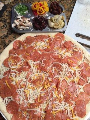 Getting ready to add our own toppings. A family size pepperoni is only $12.00 with an easy to find coupon.