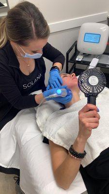 A patient getting the Clear + Brilliant facial from our licensed medical aesthetician and facial expert, Jessica.