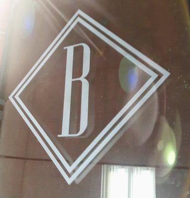 Etched logo door at the Luxury Barfield hotel in Downtown Amarillo Texas.