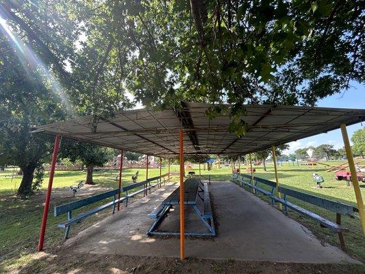 Multiple shaded seating areas and lots of benches