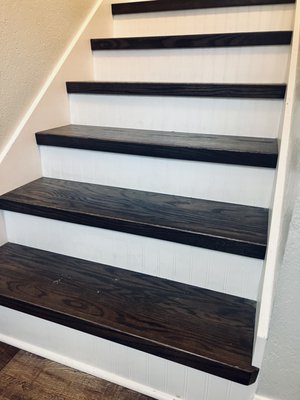 Removed old carpet, installed skirt board, stained and installed hardwood stair threads with painted white risers.