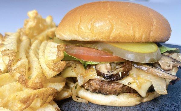 Plant-based patty seasoned to perfection topped topped with vegan cheese,  caramelized onions, sauteed shiitake mushroom, with the fixings