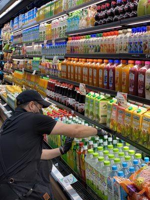 Our dedicated employee fixing the aisle. Customers and employees are both required to wear mask along with other safety standards.