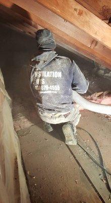 Blowing Cellulose Insulation Into A bungalow Attic.