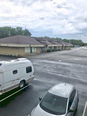 View of bar in strip mall ~ no sign