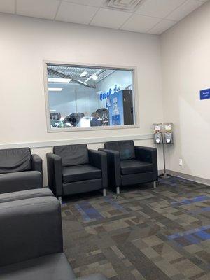 From inside the waiting room looking at the service bay