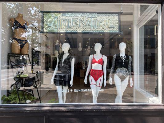 Exterior of Supernatural shop window in Birmingham, MI showing three mannequins in loungewear & lingere