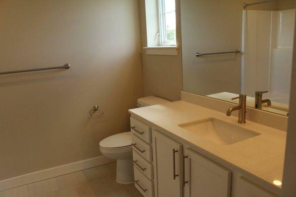 Residences at Riverwalk features beautiful countertops and large bathrooms with plenty of storage.