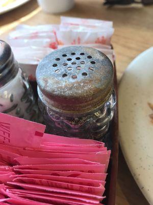 Old rusted paper can on the table