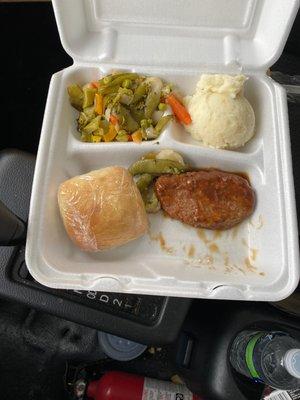 Salisbury Steak, mixed vegetables, mashed potatoes and a roll.