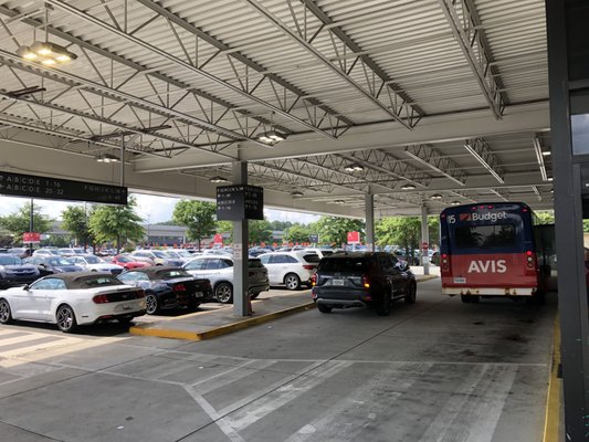 Car lot and Avis bus drop off