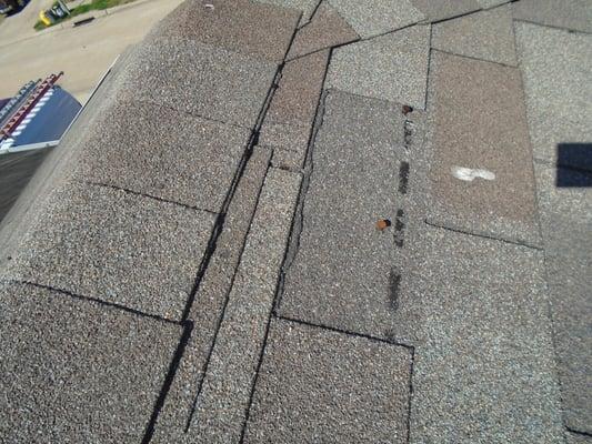 Asphalt roof tab section is missing/damaged.  Section should be replaced to prevent further roof deterioration and moisture intrusion.