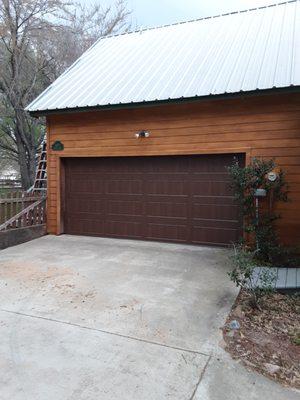 Wood grain painted metal doors are  much lighter, quieter, sturdier and longer lasting.