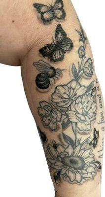 Reworked tattoo!!! Flowers softened, bee looks like a bee and sticks more obscured. Only two days old in photo. May 2023