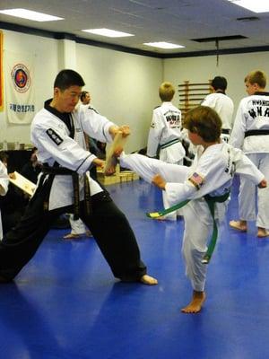 Master Hwang instructing a student. The board breaking half of belt testing.