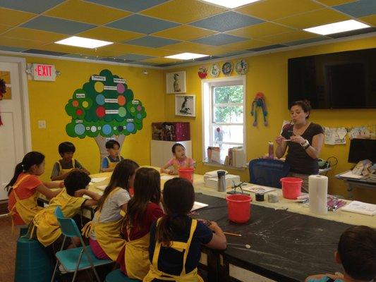 The Lead Teacher & Director of Education discussing art techniques during one of our classes!