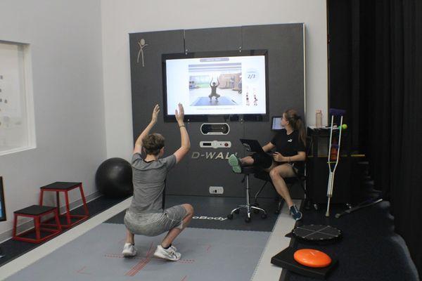 Dr. Nicole Powers, our DPT working with a player on our D-Wall.