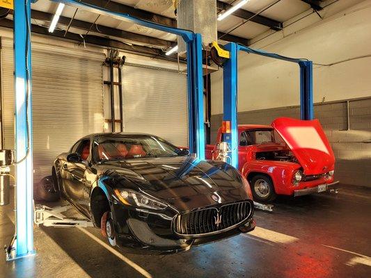 Maserati and a old school chevy truck getting repairs