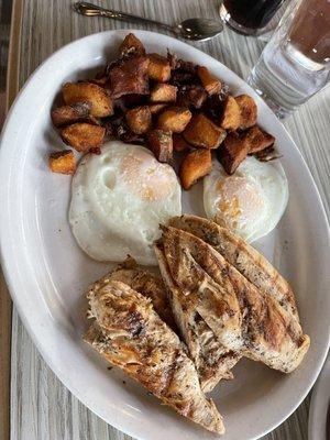 Chicken souvlaki breakfast with over easy eggs and fried breakfast potatoes