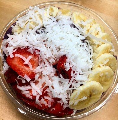 Acai Pitaya Bowl with bananas, coconut and strawberries.