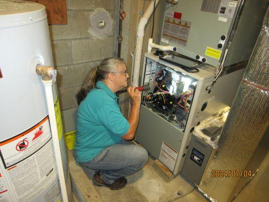 Claire checking a furnace.