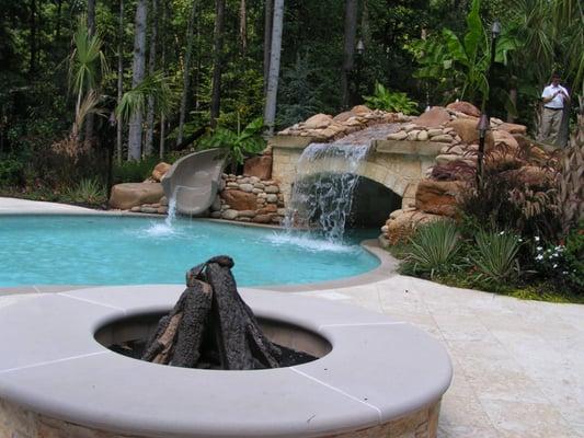 Swimming pool with fire pit, grotto and slide