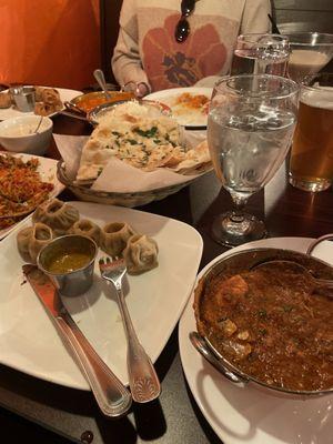 Momos, curry, achar, biryani and naan.