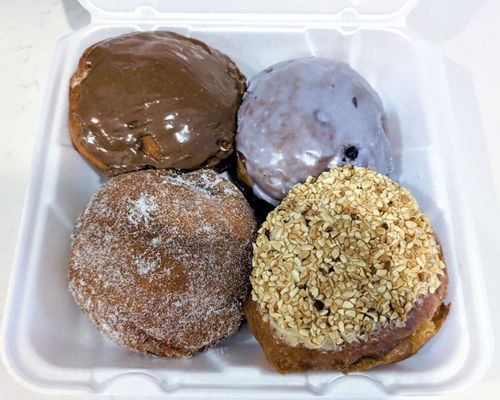 Chocolate custard, blueberry, raspberry, and peanut butter and jelly paczkis