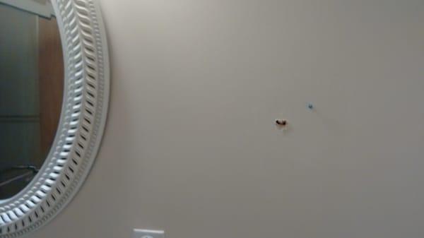 Hole in wall where towel rack was improperly installed.