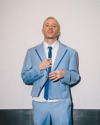 Macklemore in our bespoke baby blue cropped suit with satin trim, worn on his "Ben" tour.