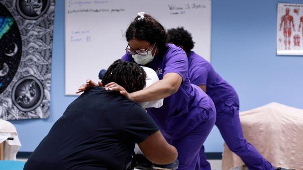 Massage Therapy students practicing in class