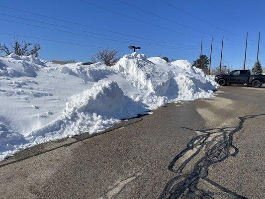 Staff parking blocked with large piles of snow