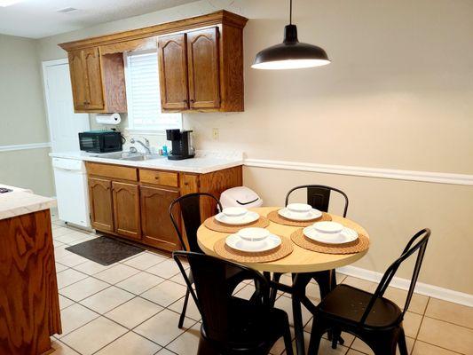 Dining Room equipped for 4 people with cookware, glassware, flatware, bakeware, large and small appliances.