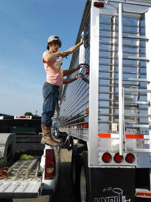 One of our part-timers lettering the side of an 18-wheeler trailer!