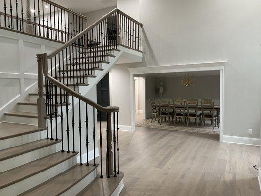 Remodeled open concept foyer with curved stair and custom lighting