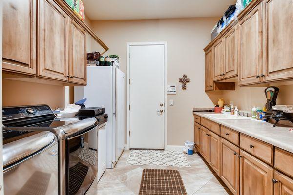 Nice size laundry with built-in cabinets. Appliances stay!