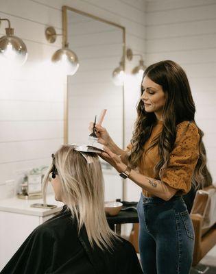 Kyra Devens blonding hair in Coeur d' Alene at The Copper Label.