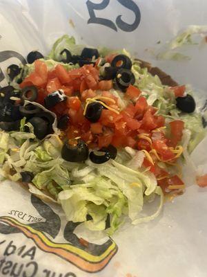 A sad Super Tostada with NO CHEESE! I didn't order no cheese. It's my favorite thing about all of their food!