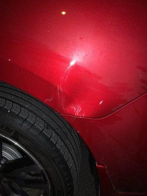 Driver side back tire dent