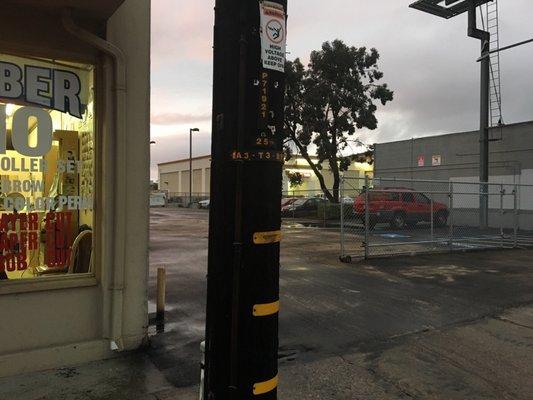 The property owners have paved, & fenced in the salons parking lot December 2016