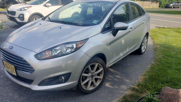 Dirt all over the car. The wheels are covered in brake dust