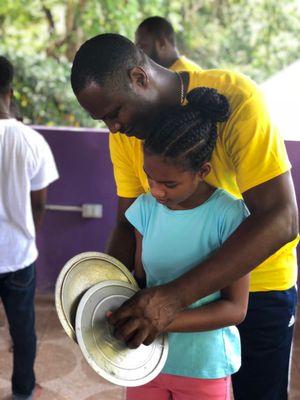 Learning Jamaican rhythm using pot covers