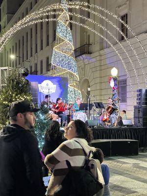 A string quartet playing Christmas tunes.