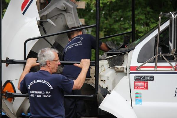 Gramp and Scotty working on one of several big trucks we service