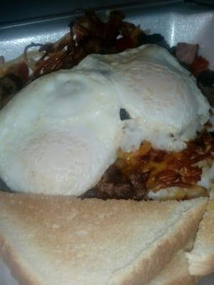 Meat lovers skillet with over easy eggs and toast mmm