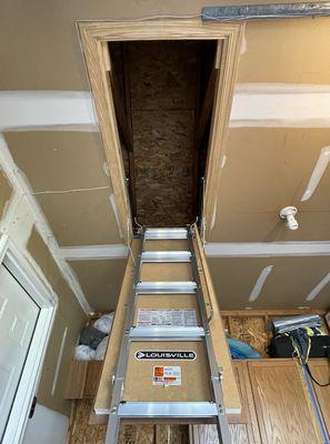 Garage attic ladder to increase storage space