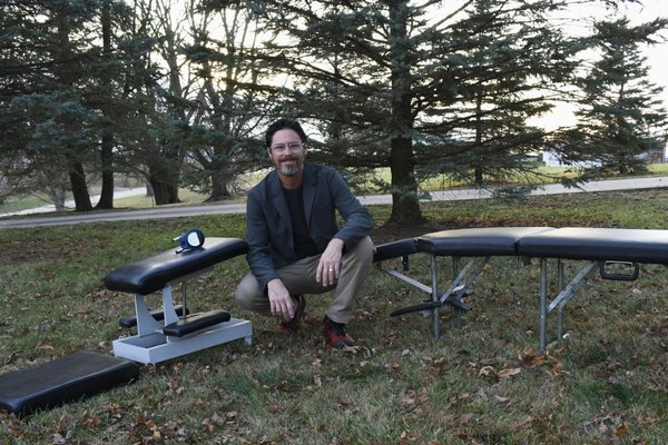 Dr Travis Worthman with mobile chiropractic tables.