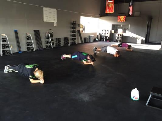 Gun's Fitness Studio Clients performing Planks during their Boot Camp Training Session.