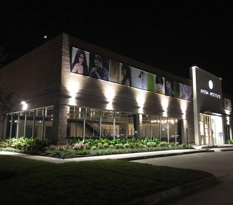 Aveda Institute Baton Rouge building at night.