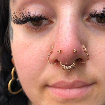 Paired forward facing nostril piercings aka Mantis piercings with solid gold jewelry by Kenzie at IRIS Studios Grand Rapids